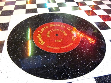 At the Denver location, guests are welcomed by a giant-sized reproduction of a Jerry Lee Lewis record, “Who Lotta Shakin Goin’ On,” set into the tile floor.