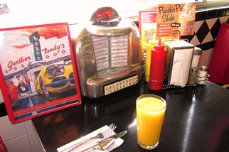 Memorabilia peppers the interior of Gunther Toody’s. Our table had a non-working remote jukebox unit. Note orange juice in an actual glass.